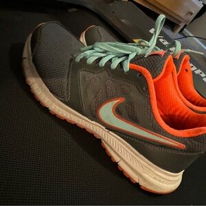 Nike tennis shoes. Grey with blue shoe strings